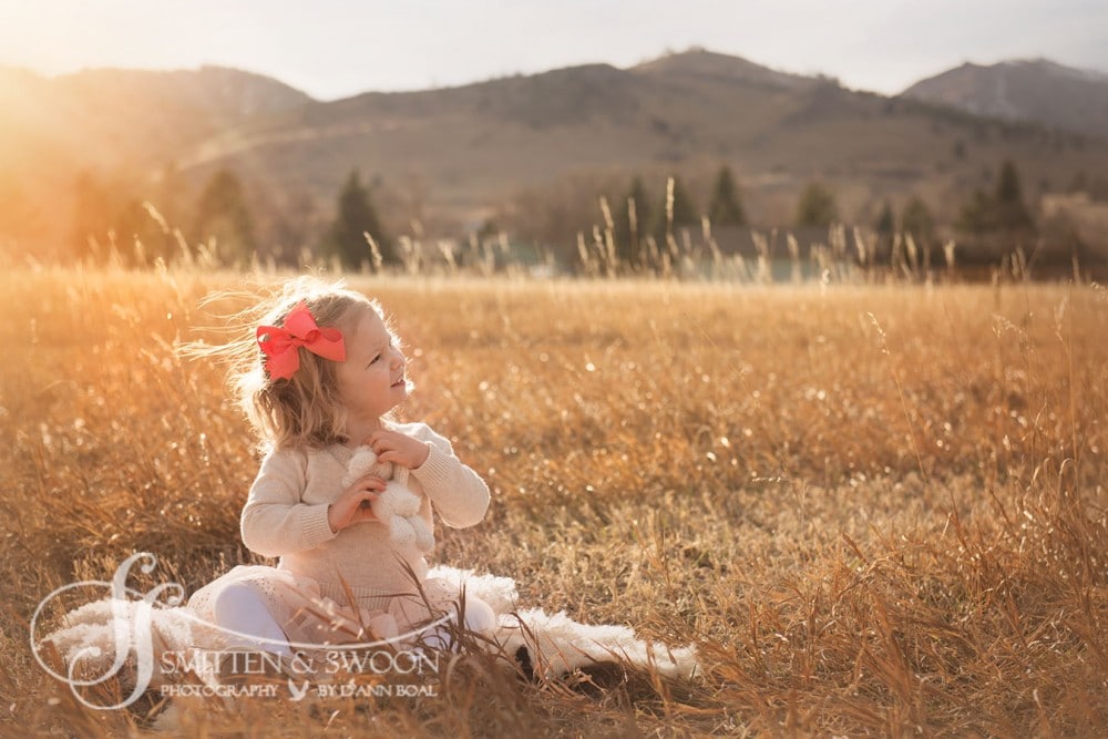 little girl in golden field sitting in the grass {boulder child photographer}