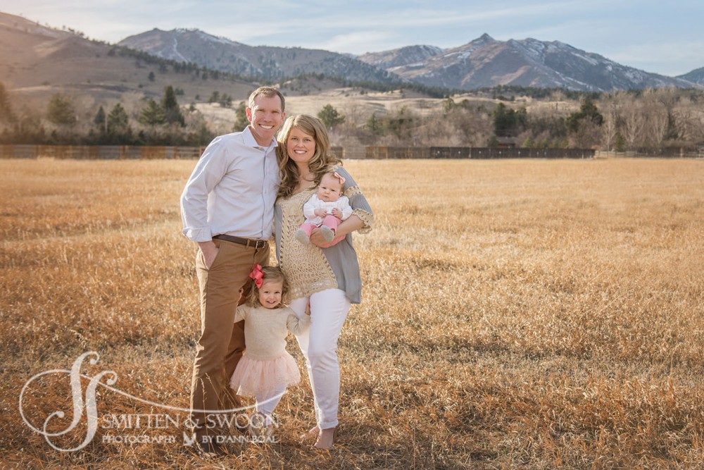 family of four portrait in field with mountain views {boulder family photographer}