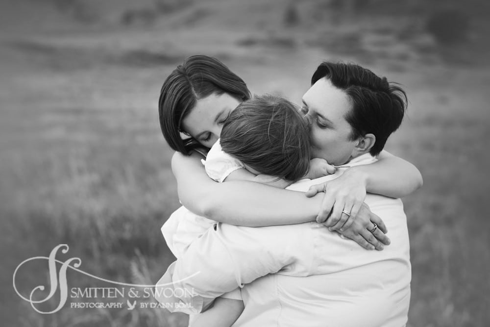 two moms hugging their daughter {boulder family photographer}