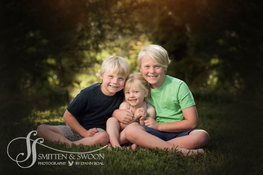 brothers and sister hugging and smiling {boulder family photographer}