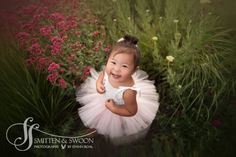 baby girl in garden smiling {boulder baby photographer}