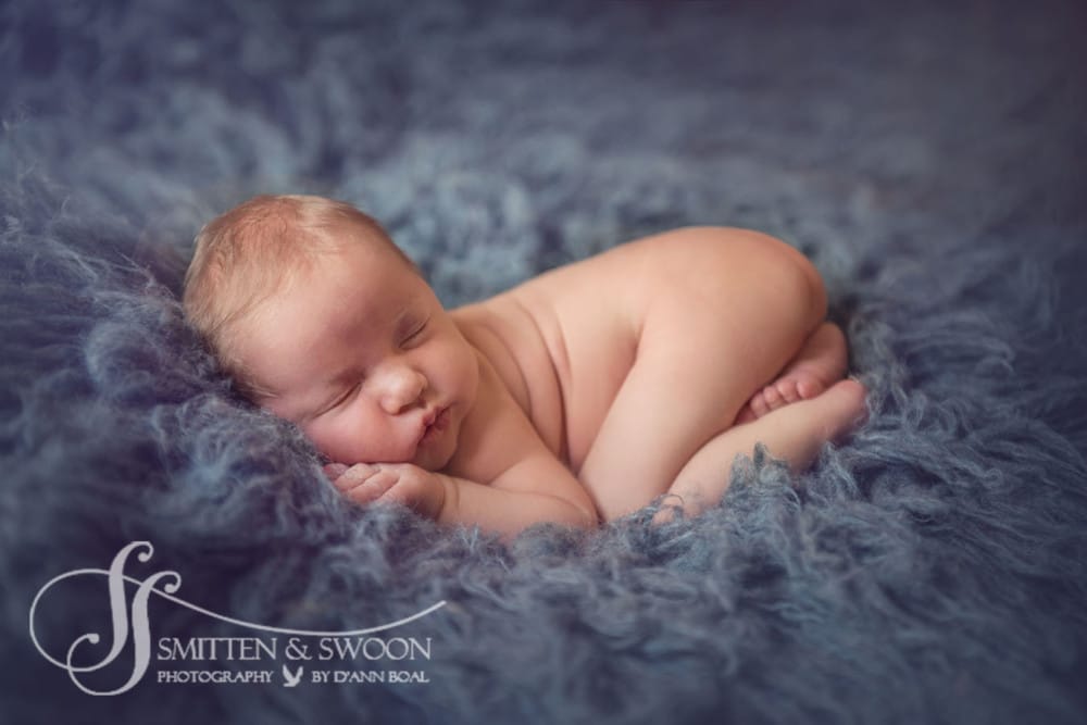 newborn baby boy sleeping knee to elbow pose in blue {boulder newborn photographer}