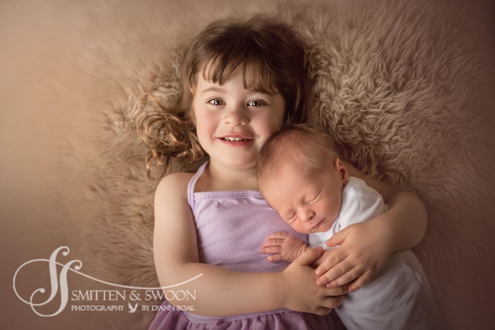 big sister holding her newborn baby brother {boulder newborn photographer}