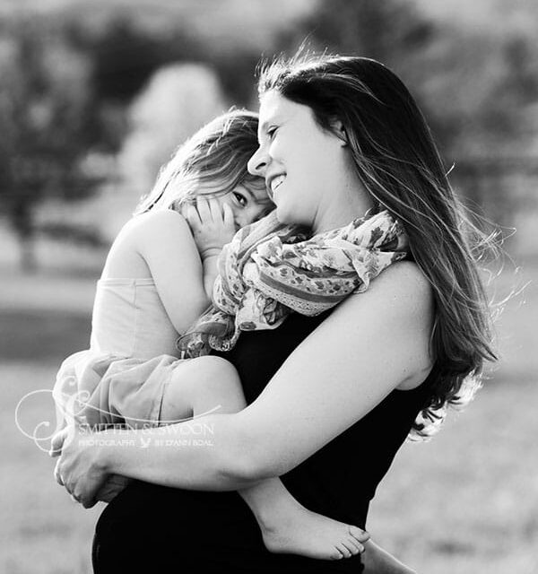 pregnant mom holding her baby girl smiling {boulder maternity photographer}