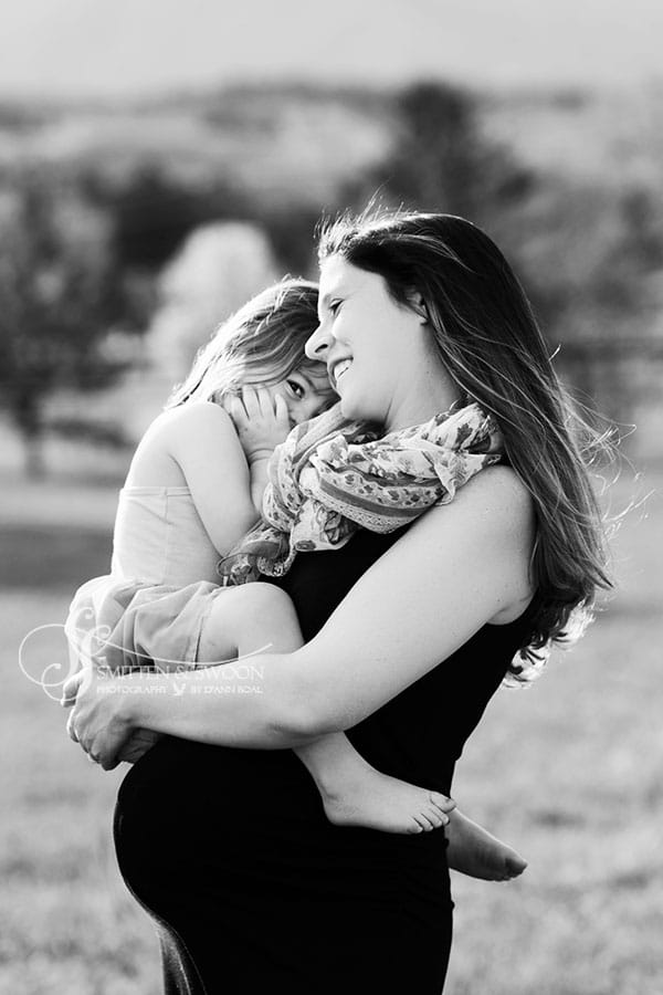 pregnant mom holding her baby girl smiling {boulder maternity photographer}