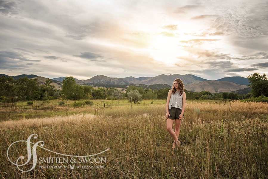 senior portrait girl standing in field at sunset with mountain views {boulder senior photographer}