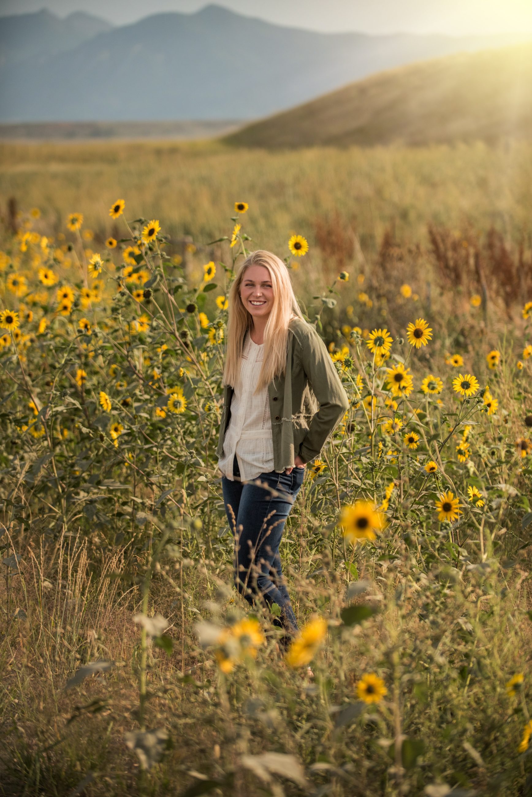high school senior standing in sunflower field at sunset - boulder senior photographer