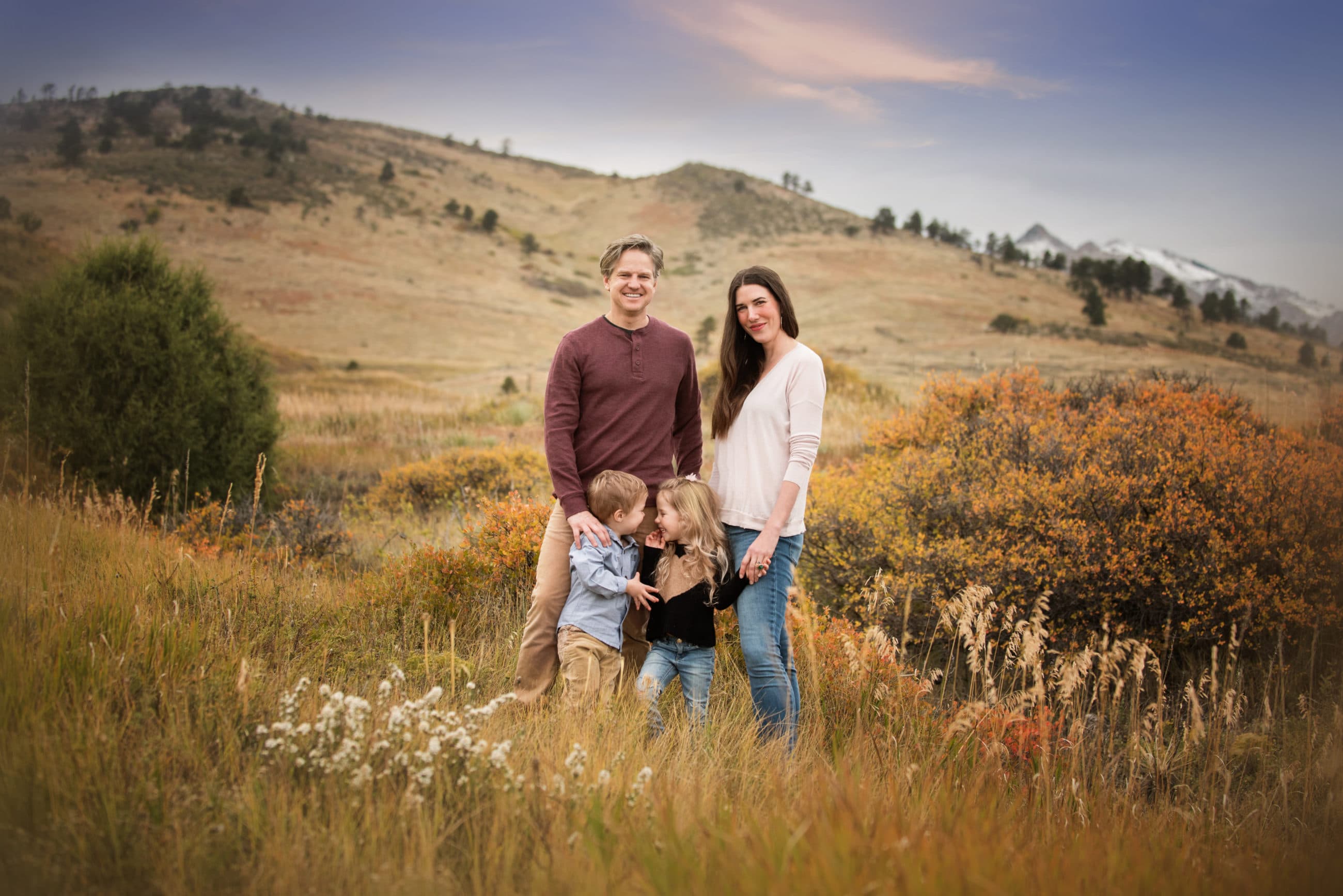 boulder photographer - family of four smiling in beautiful field