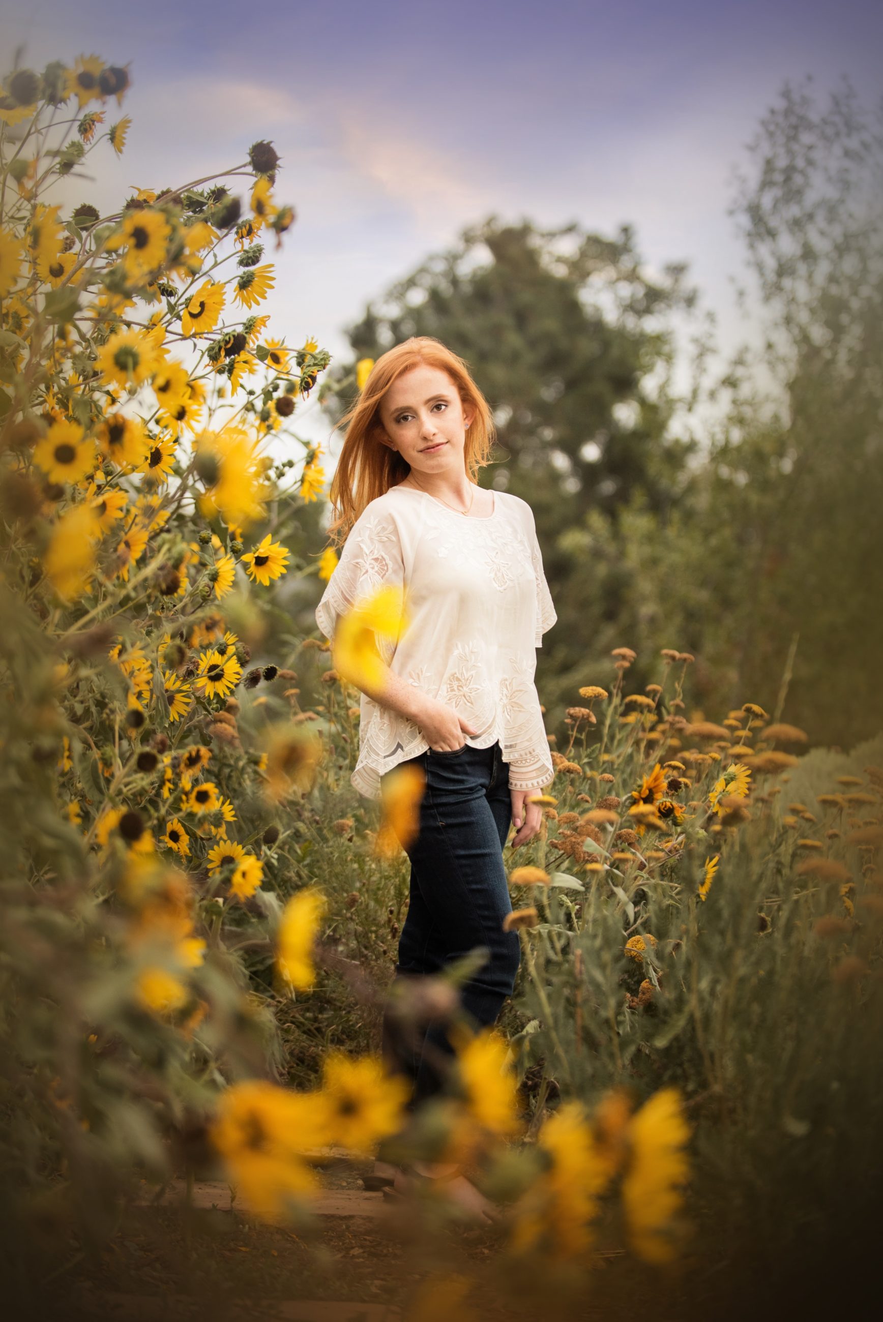 senior photo girl standing in field of sunflowers - boulder senior photographer