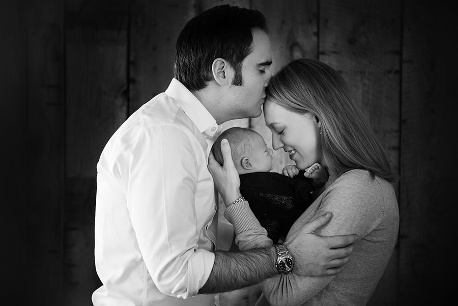 family kissing holding their newborn baby boy - boulder photographer