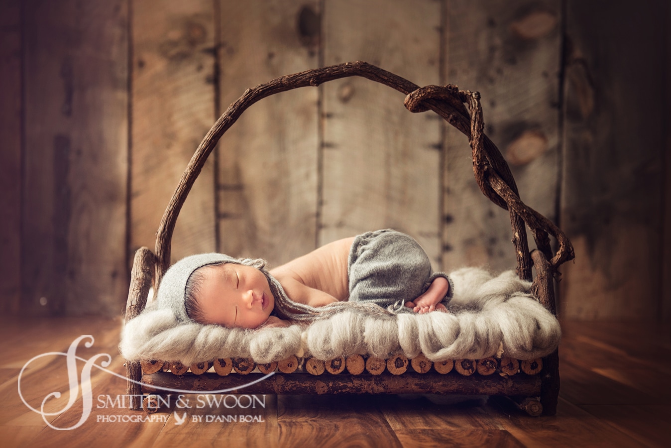 newborn baby boy in wooden bed boulder photographer