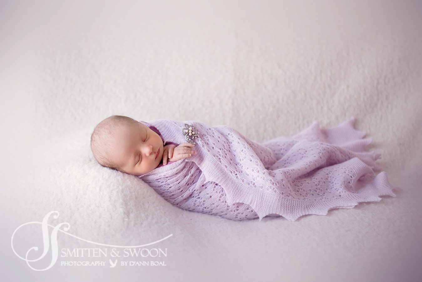 newborn baby wrapped in lavender boulder newborn photographer