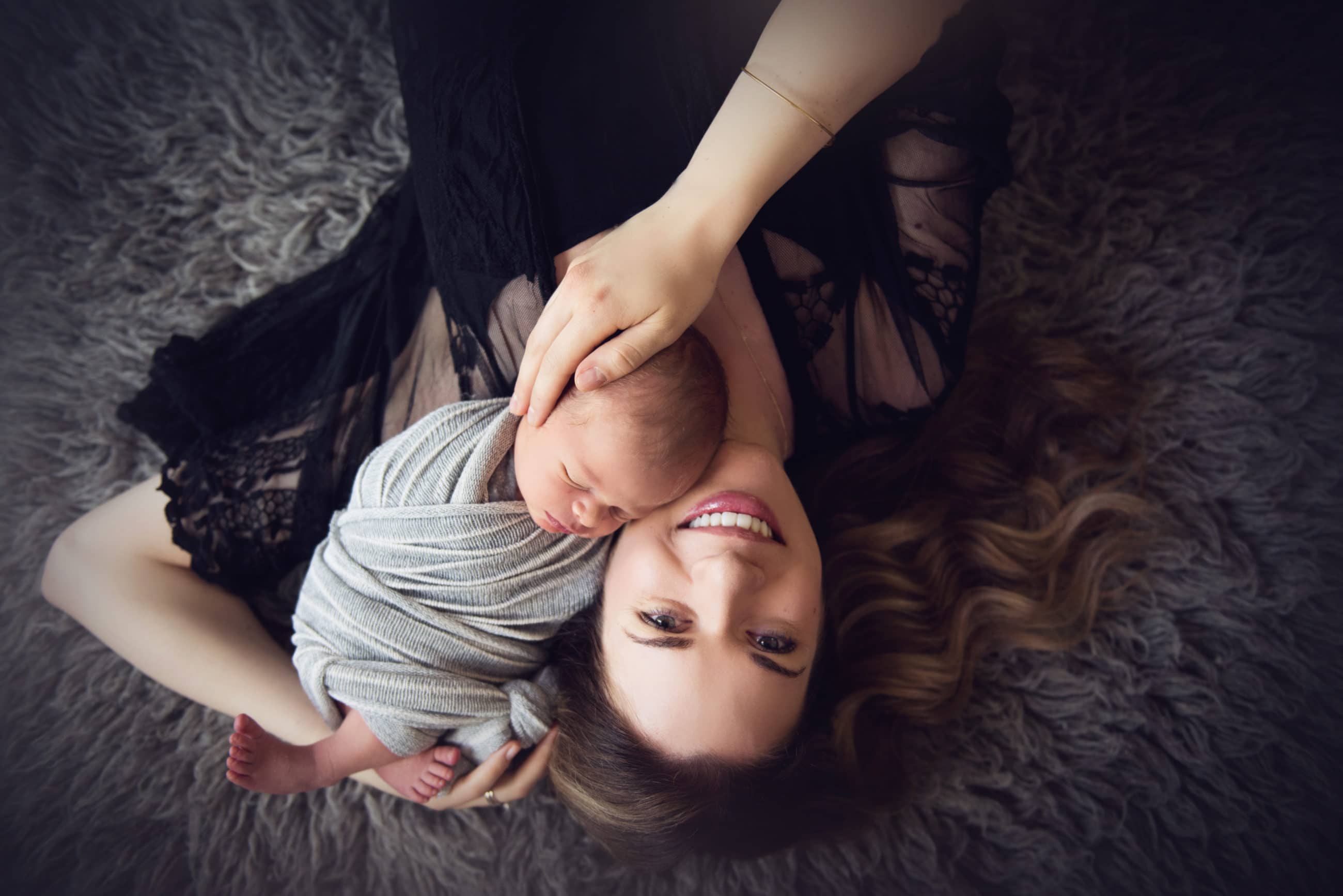 mom and newborn baby boy from above - boulder portrait photographer