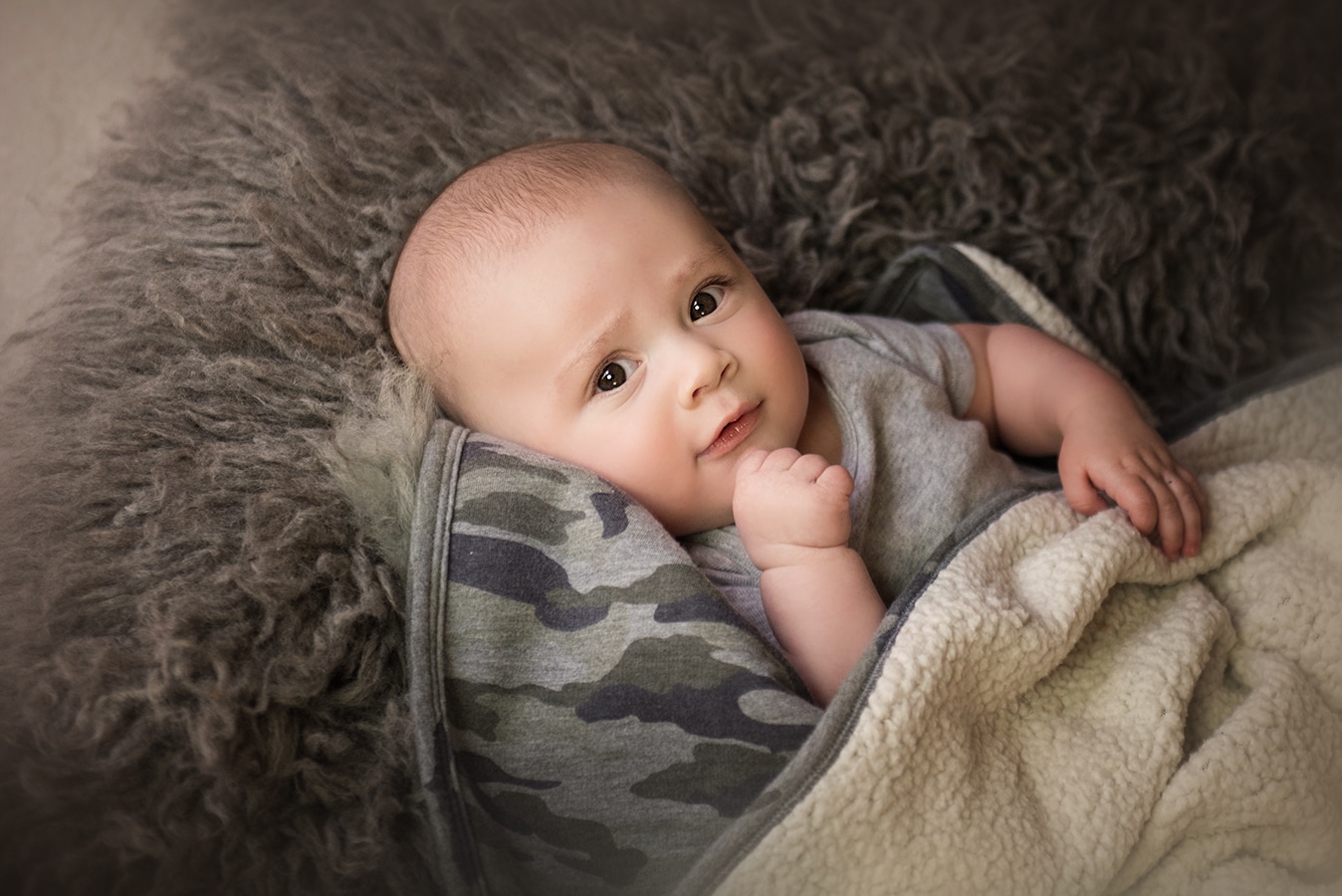 cute baby boy laying on camo blanket - boulder newborn photographer