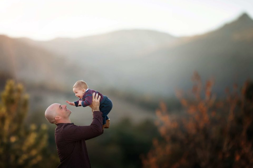 little boy in dad's arms fall foliage and mountain background - boulder photographer