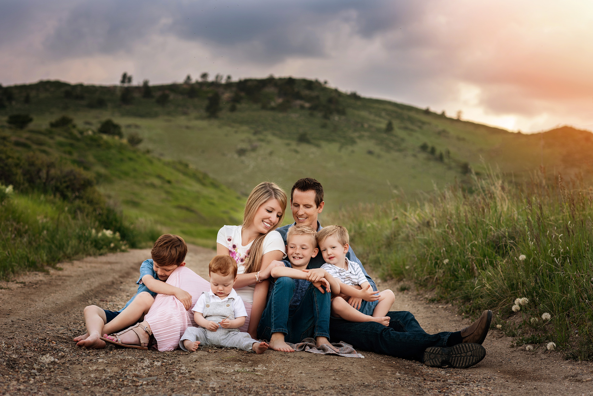 family of six sitting together on dirt road Boulder newborn child & family photographer | the experience