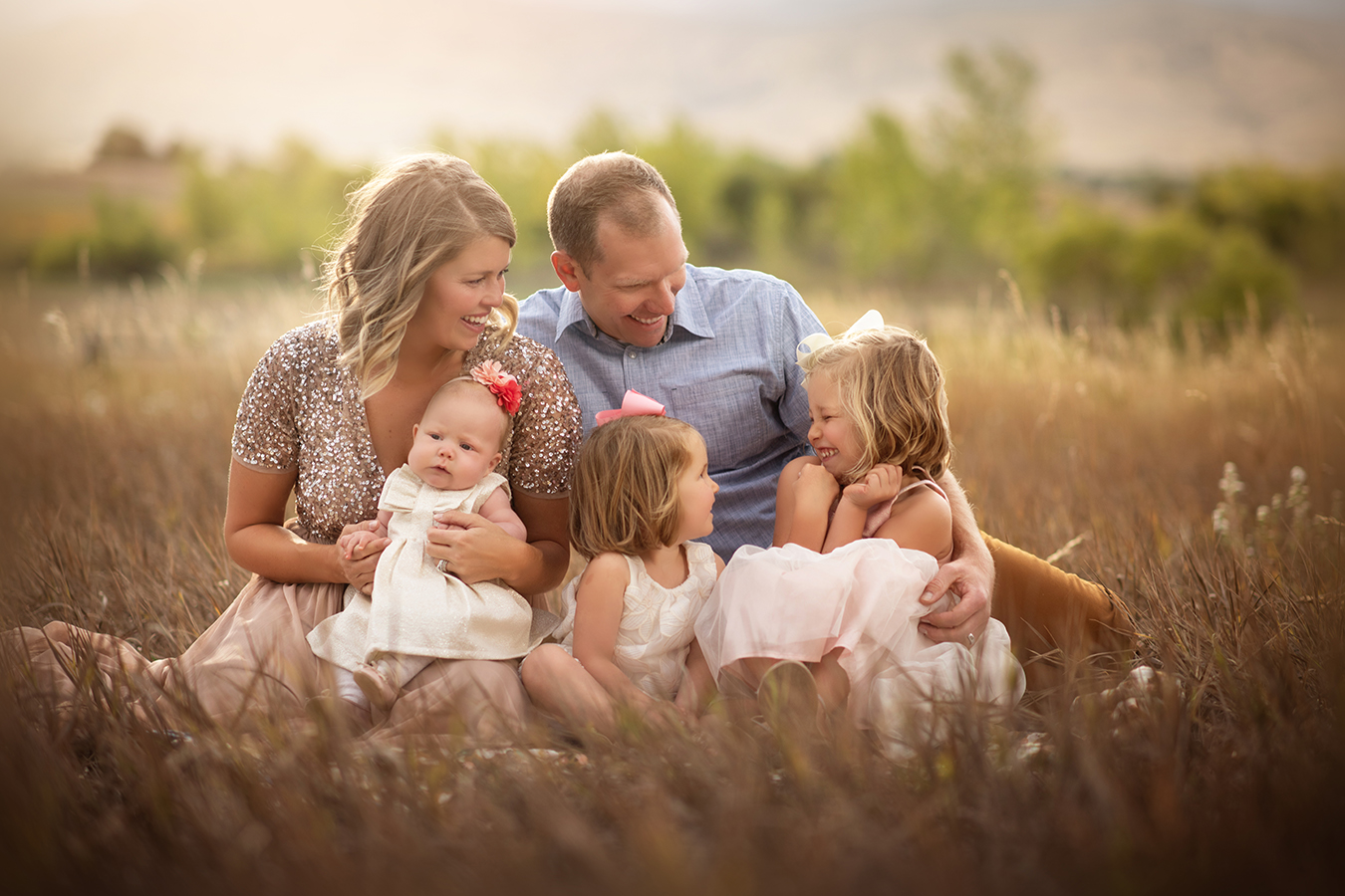 family of five sitting in golden field - boulder photographer
