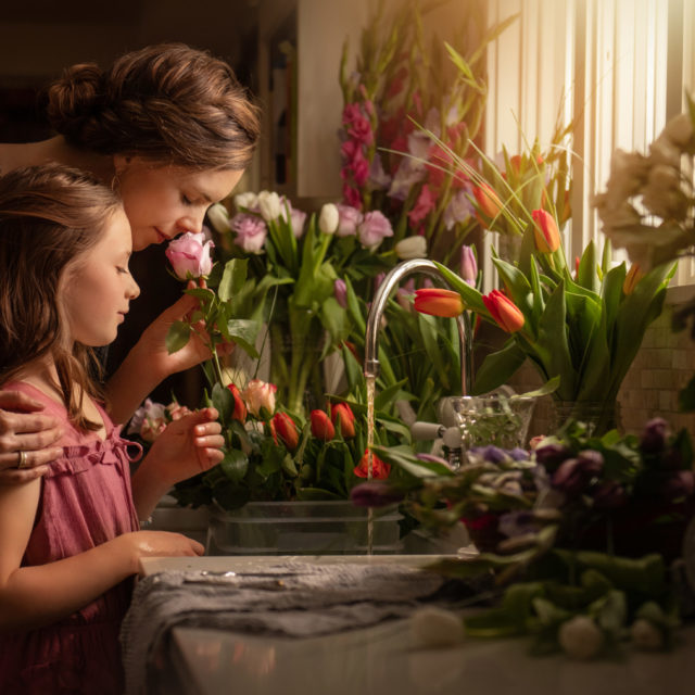 boulder Colorado photographer - mom and daughter smelling a hundred flowers in kitchen