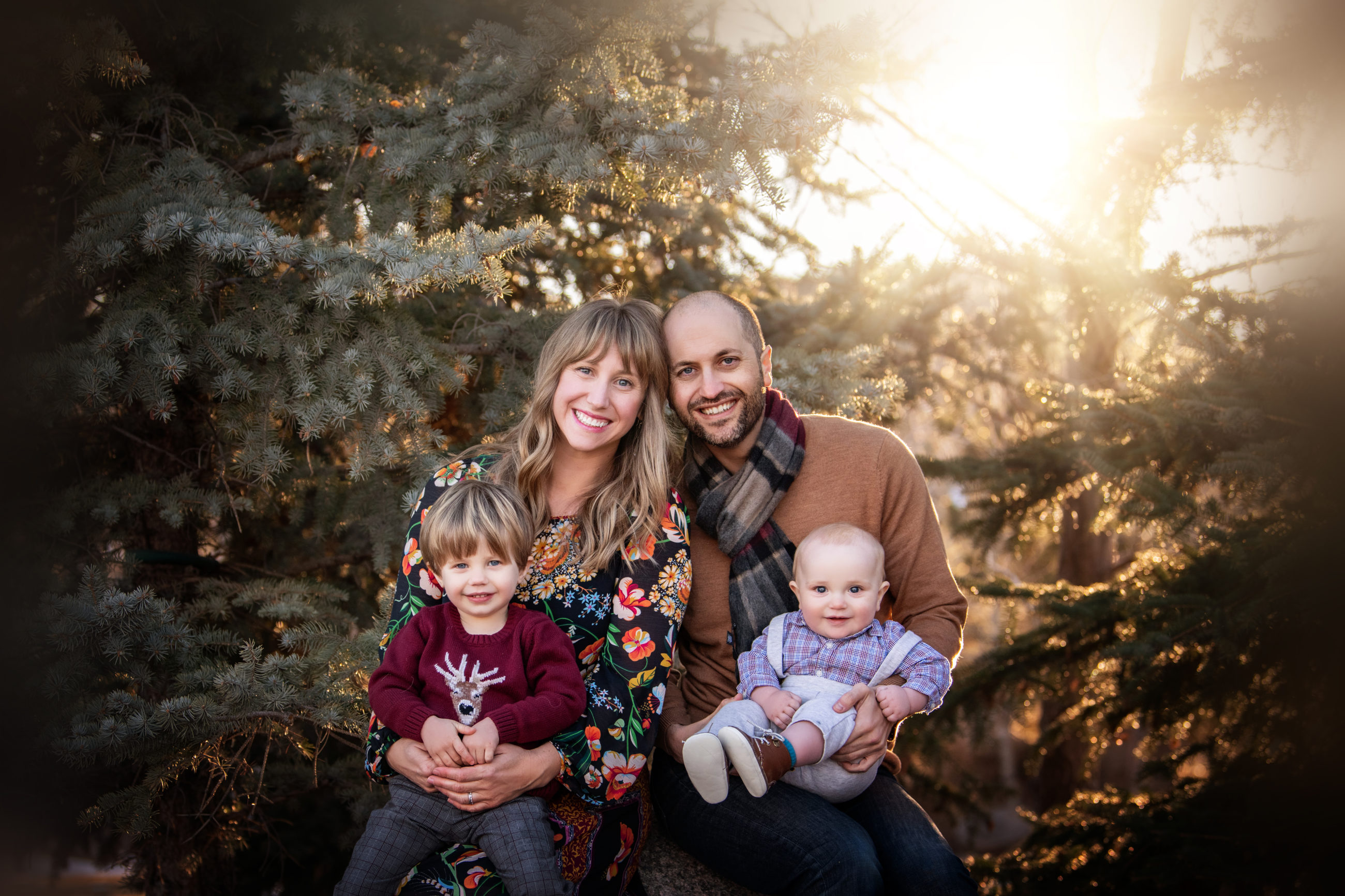 love and light - boulder photographer - family of 4 portrait in backlight with pine trees