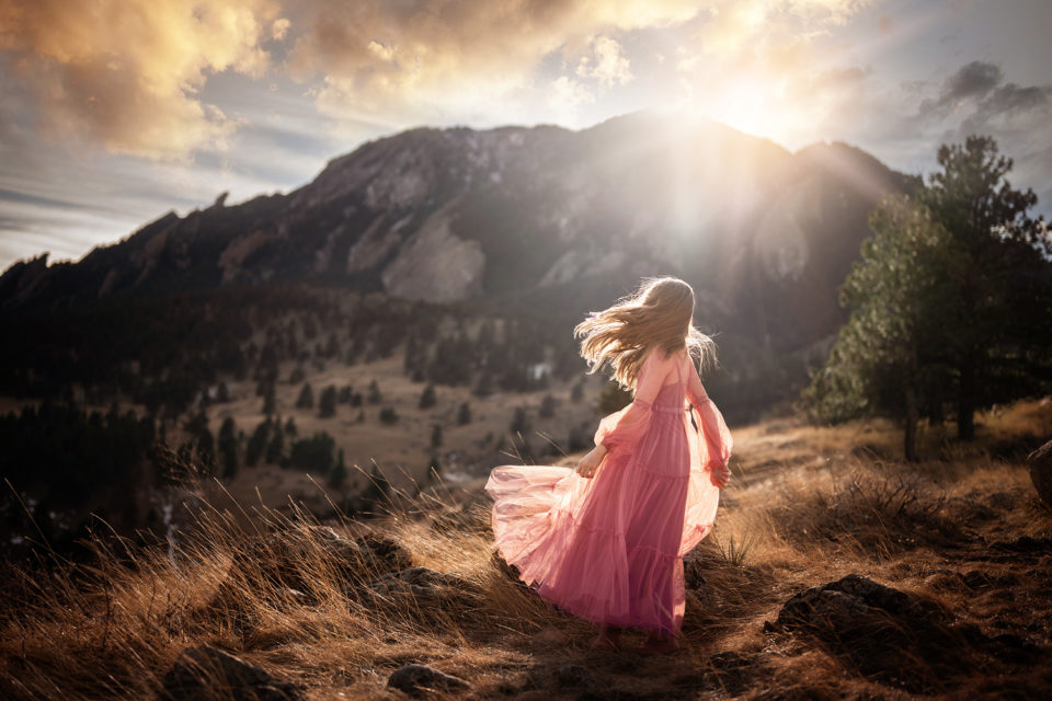 best photographer in Colorado - girl in pink gown on mountaintop at sunset
