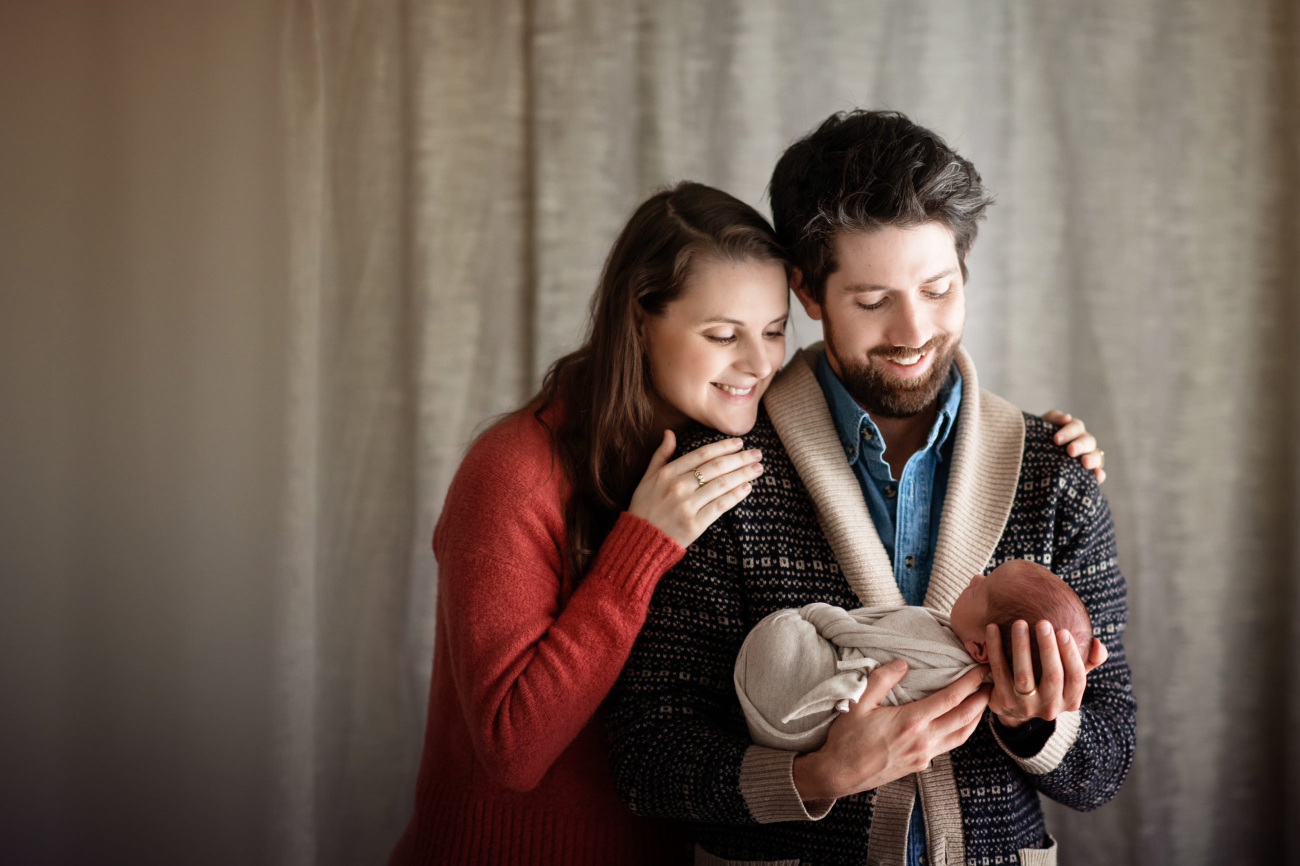 mom and dad holding newborn baby boy - boulder's best photographer