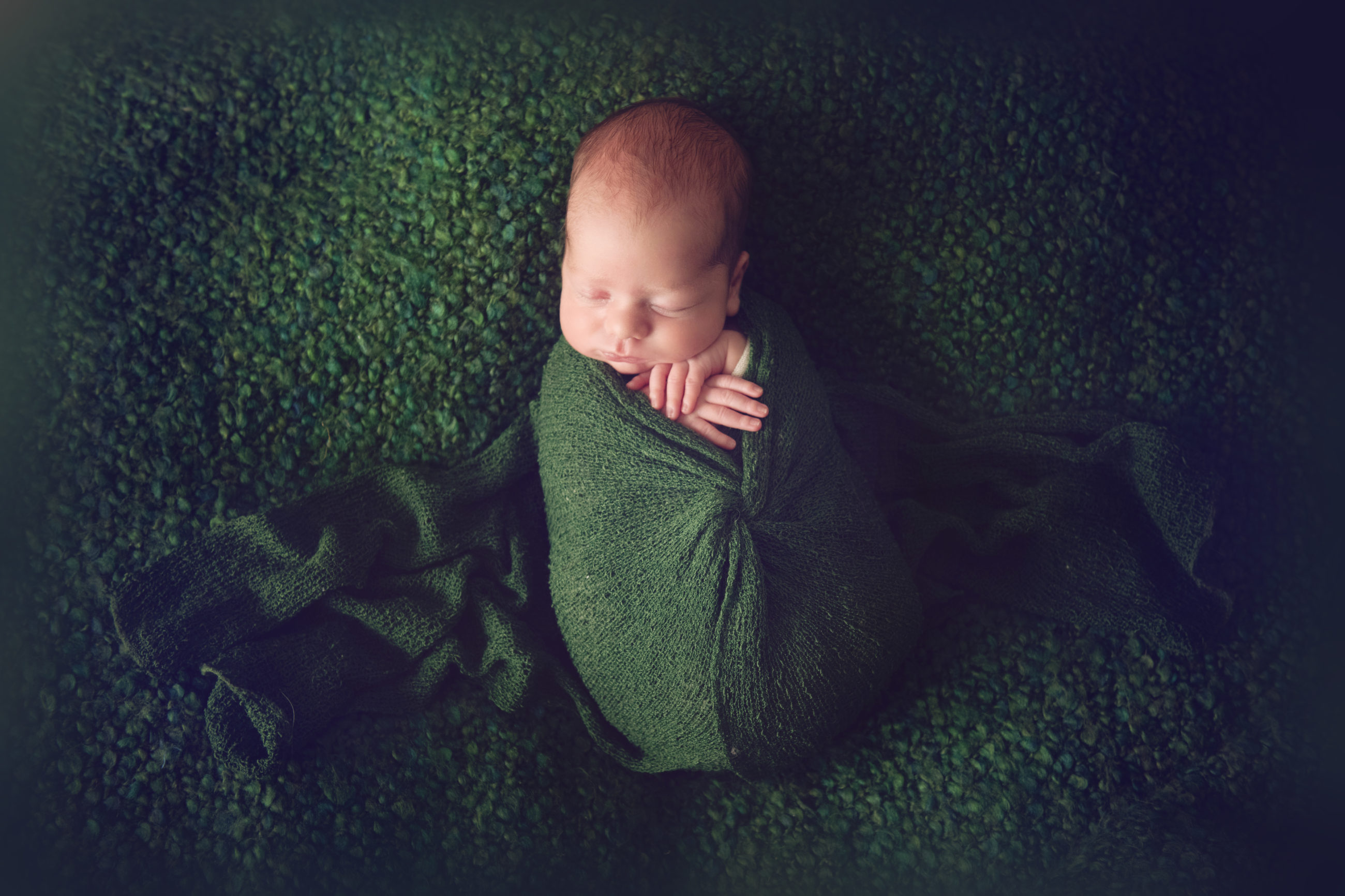 best baby photographer in boulder - newborn baby sleeping in green wrap